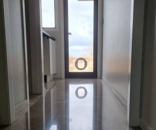 Salt and pepper finish for a beach house polished concrete floor nz grinders tauranga hallway