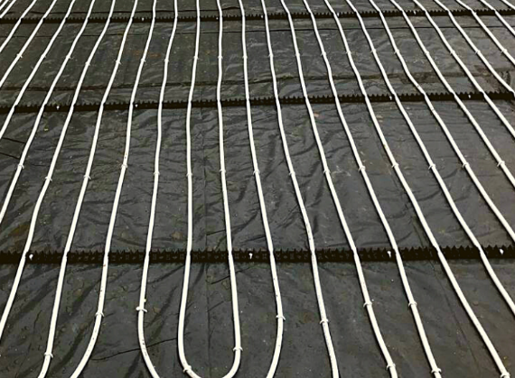 Underfloor heating coil on floor polished concrete